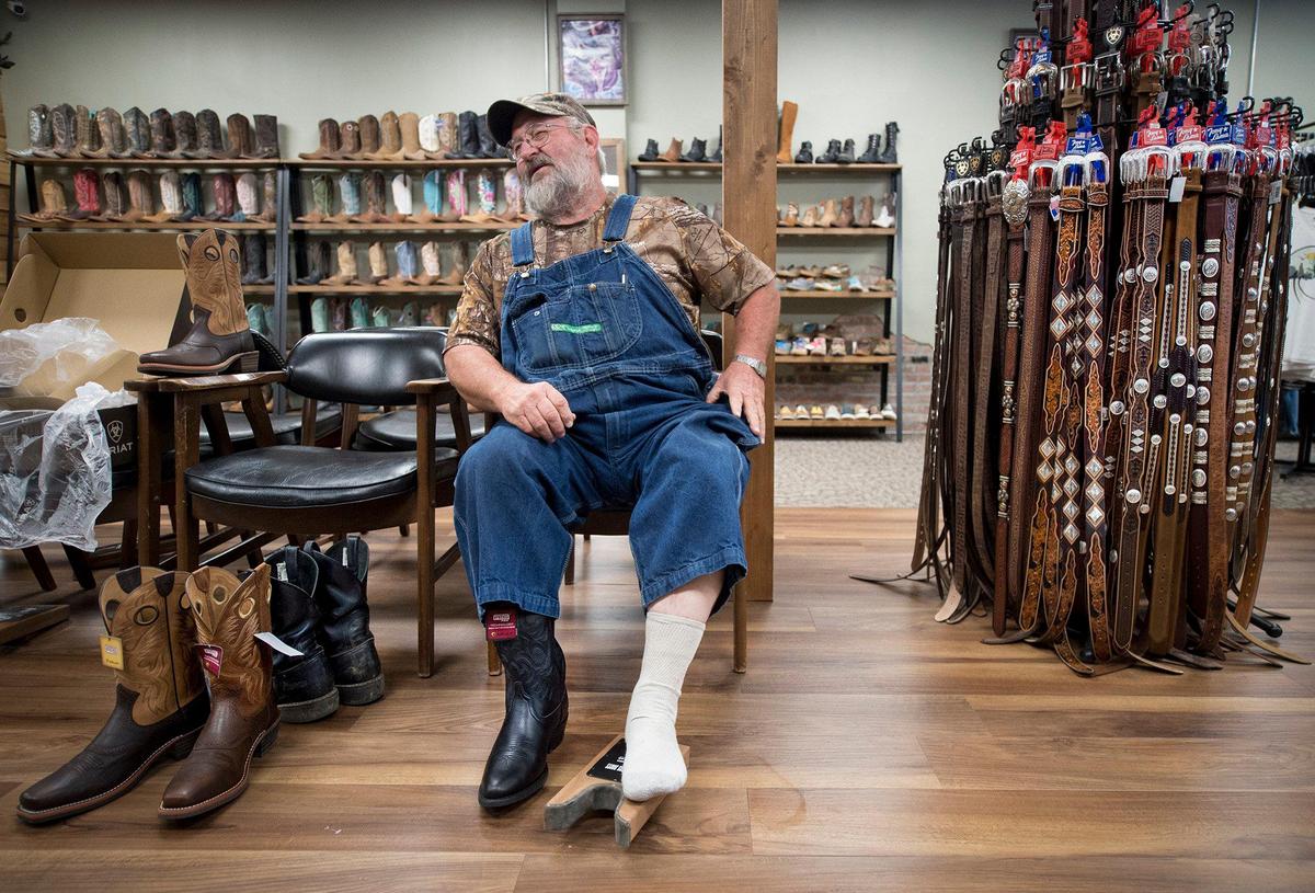 “I need the mail to come into my business,” said William Witt of Stockton, Missouri, as he tried on boots Wednesday at Jones Boots in Sheldon, Missouri. Witt, a logger, saw mill operator and mule rider, said losing the post office would be a big hardship. “I don’t do the email and the electronic stuff like other people,” Witt said. “I’m too old to learn.”