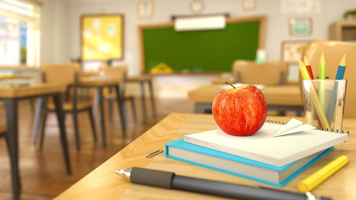 book, pen, pencils and red apple on desk in empty classroom. 3D rendering illustration. Back to school Teacher education class