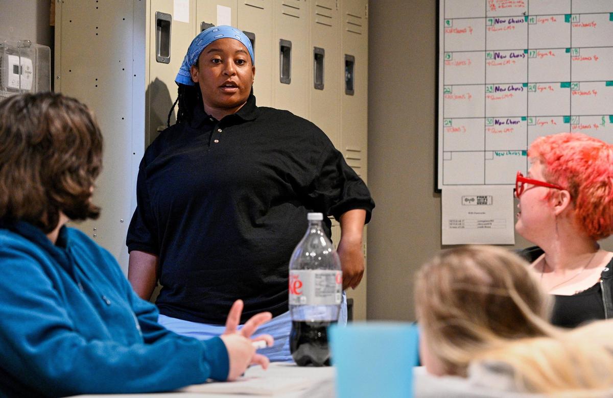 Star Palmer, center, leads a meeting at a youth transitional house in Kansas City, Kansas, run by the nonprofit Our Sport KC, where she is executive director. Palmer has also recently taken on a top leadership role at the Kansas City Pride Community Alliance.