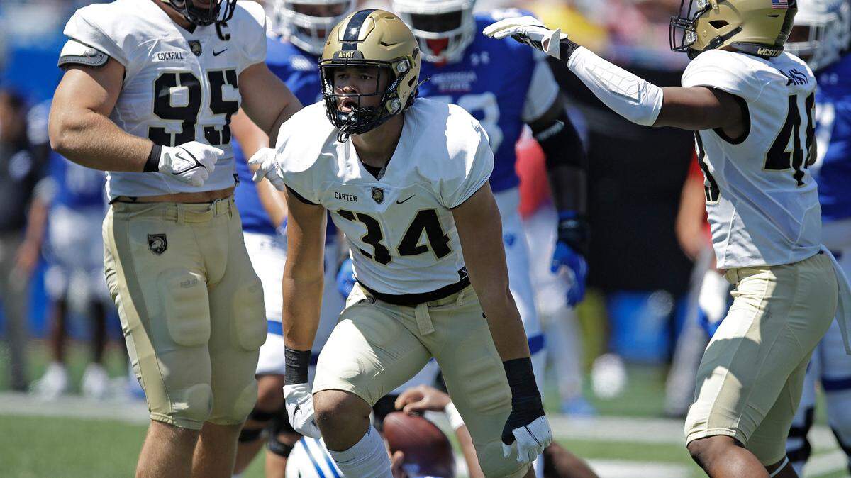 FILE - Army linebacker Andre Carter II (34) celebrates after sacking Georgia State quarterback Cornelious Brown IV (4) during the first quarter of an NCAA football game Saturday, Sept. 4, 2021, in Atlanta.Carter II has become a disruptive force for the Black Knights in his first full season as a starter. The 6-foot-7, 250-pound junior from Missouri City, Texas, leads the nation with 1.32 sacks per game. (AP Photo/Ben Margot, File)