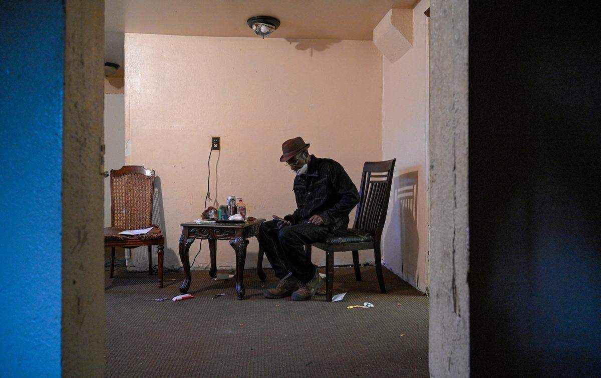 Joe Amrine checks messages as he gets ready for work Wednesday, Oct. 27, 2021. This day is his 65th birthday, which means he is eligible for Medicare. Amrine spent 17 years on death row and was exonerated in 2003. Without job skills or being eligible for benefits, he has struggled.