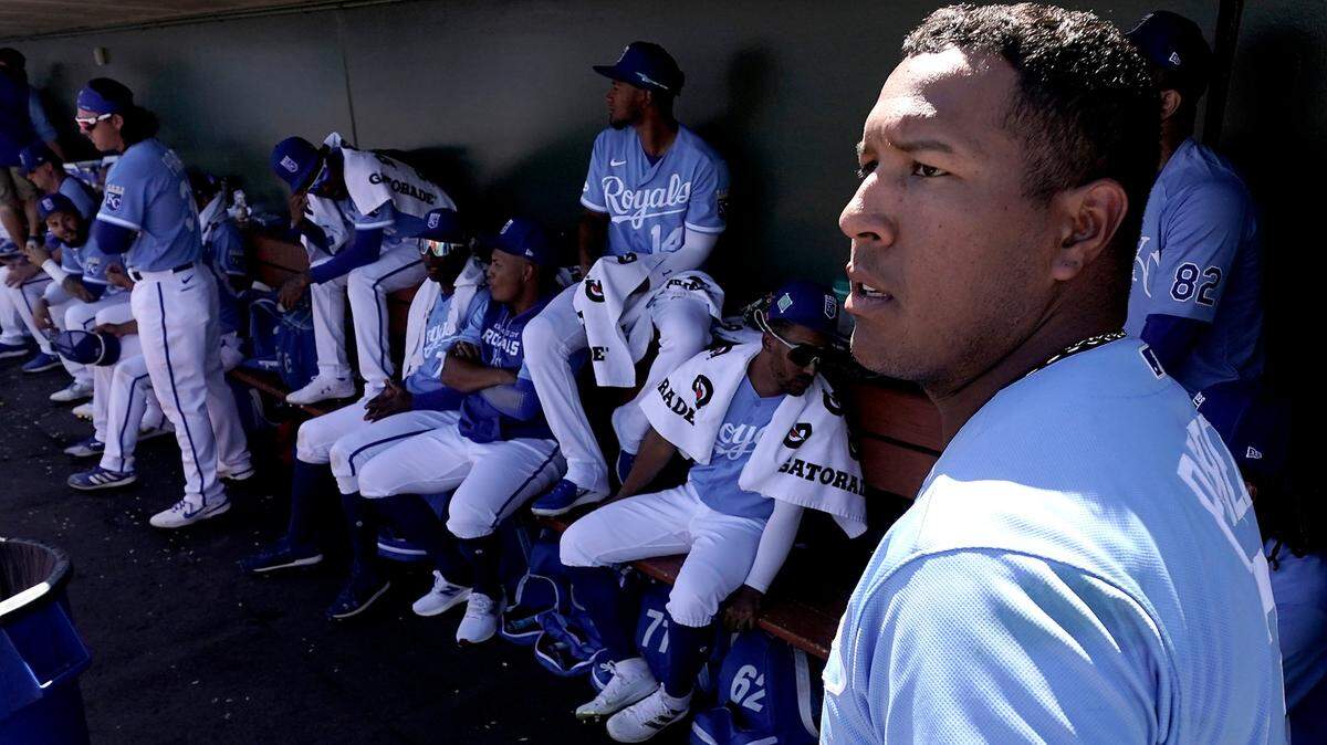 Kansas City Royals’ Salvador Perez watches from the dugout as he waits to bat during the second inning of a spring training baseball game against the Cincinnati Reds Thursday, March 24, 2022, in Surprise, Ariz. (AP Photo/Charlie Riedel)