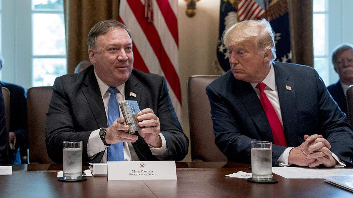 Former Secretary of State Mike Pompeo and former President Donald Trump chat during a White House cabinet meeting in 2018. Pompeo, Sen. Josh Hawley and other Republicans from Kansas and Missouri lambasted the incidetment of former President Donald Trump.