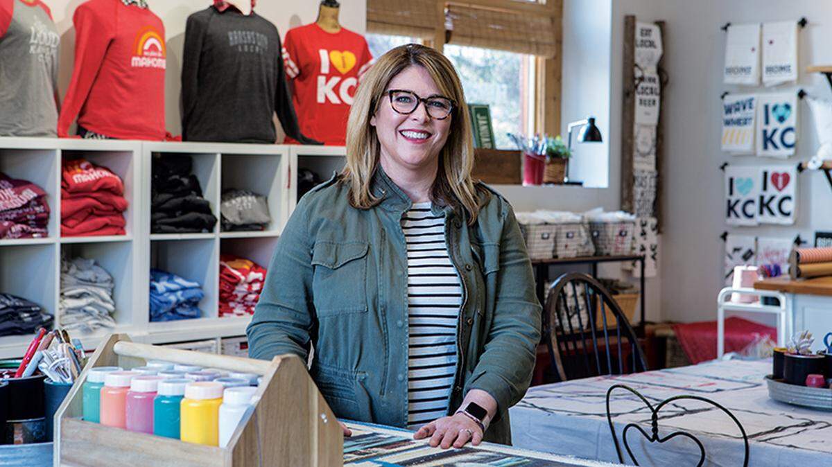 Amy January of Farmdog Studios makes wood signs and custom decor that celebrates neighborhoods such as Brookside, where her business is located.