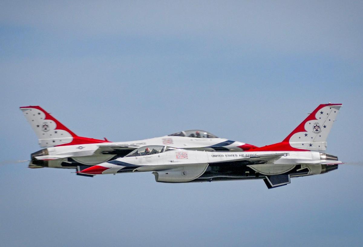 Two U.S. Air Force Thunderbirds pass each other in close proximity and at high speed after arriving from Las Vegas at the New Century AirCenter on Thursday, Sept. 1, 2022, in Gardner, Kansas, for the Garmin KC Air Show, which runs Saturday and Sunday. The show features the Thunderbirds, who are on hand to celebrate the U.S. Air Force’s 75th anniversary, and their 69th anniversary. The elite flight squadron will fly in formation at speeds from 150 to 700 mph and at times will be only 18 inches apart.