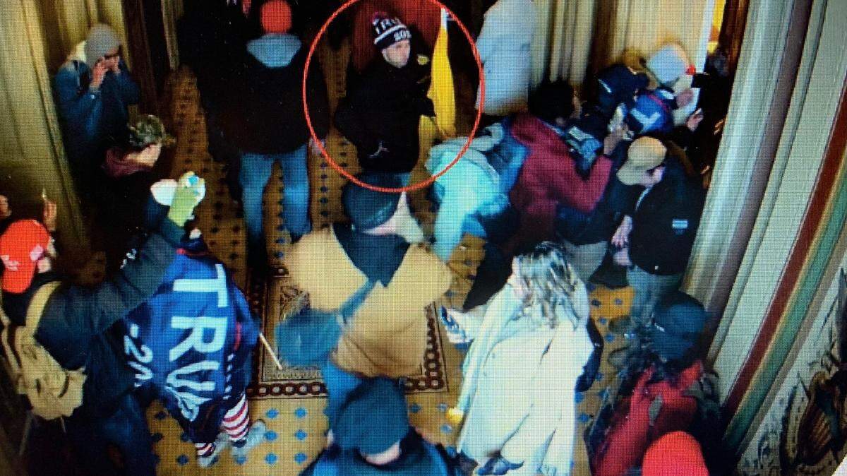 A man the FBI says is Mark Roger Rebegila of St. Marys, Kansas, is shown (inside the red circle) on U.S. Capitol closed-circuit television roaming through the building on Jan. 6.