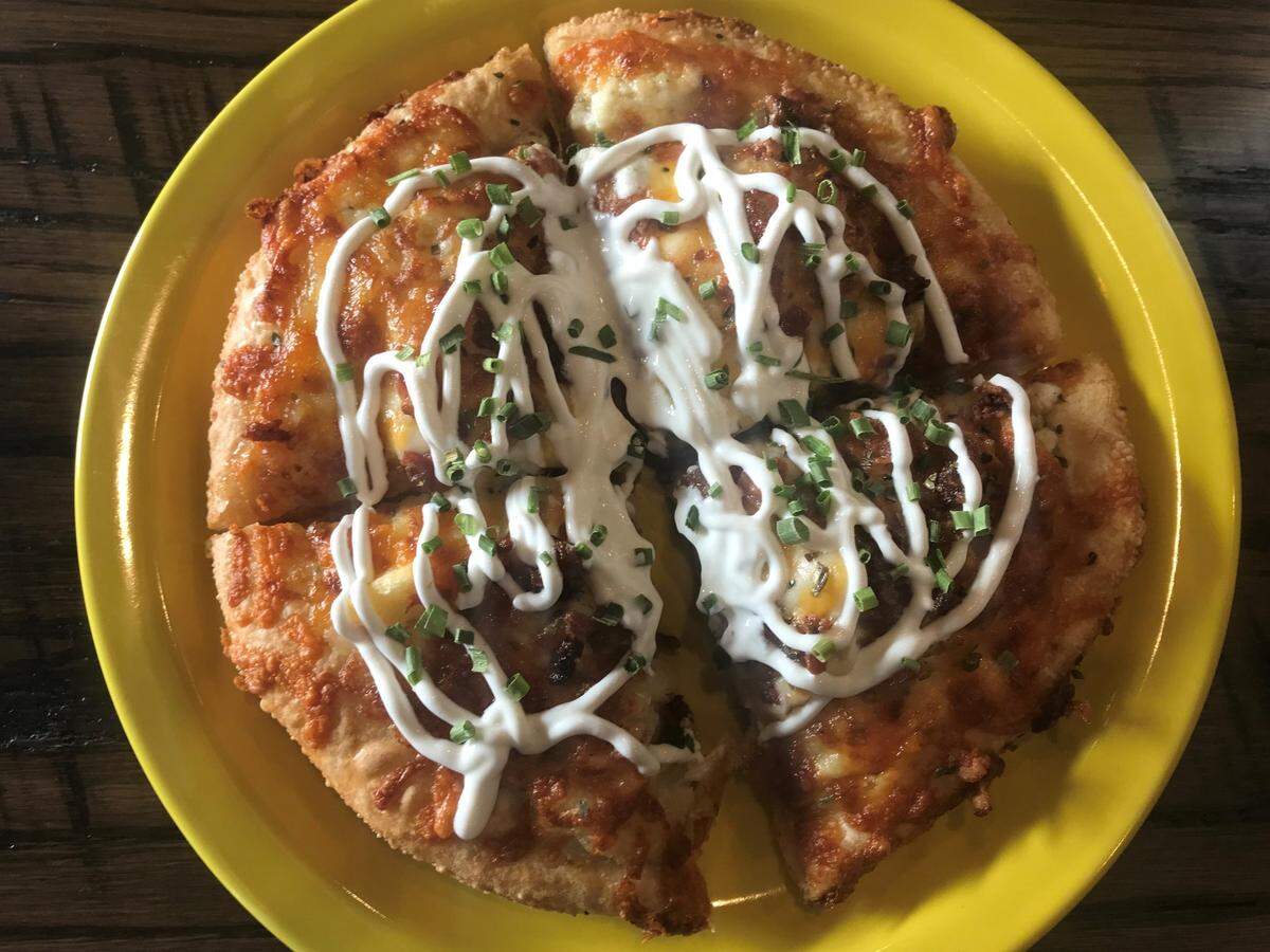 Glory Days Pizza’s Baked Potato pizza with ranch dressing, mozzarella and cheddar cheeses, bacon garnish and topped with sour cream and chives.