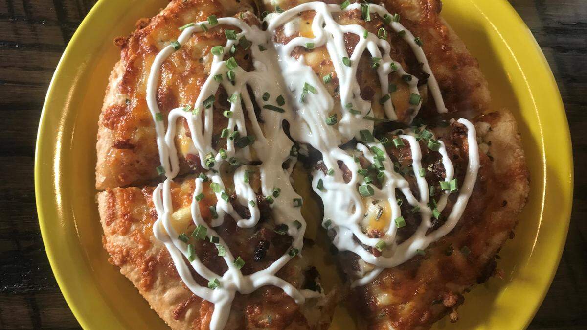 Glory Days Pizza’s Baked Potato pizza with ranch dressing, mozzarella and cheddar cheeses, bacon garnish and topped with sour cream and chives.