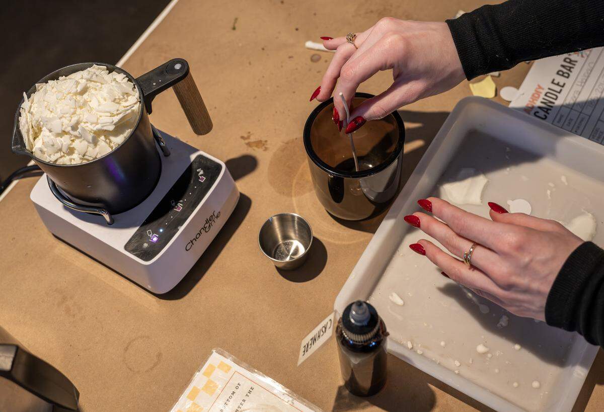 A guest prepares materials for candle-making at ADHDIY Craft Cafe on Saturday, Feb. 7, 2026, in Kansas City.