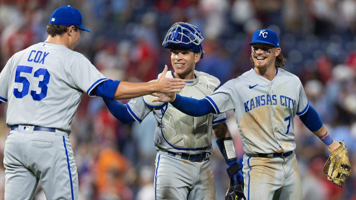 Kansas City Royals relief pitcher Austin Cox (53), catcher Freddy Fermin (34) and shortstop Bobby Witt Jr. (7) celebrate a victory against the Philadelphia Phillies at Citizens Bank Park in Philadelphia on Aug. 4, 2023.
