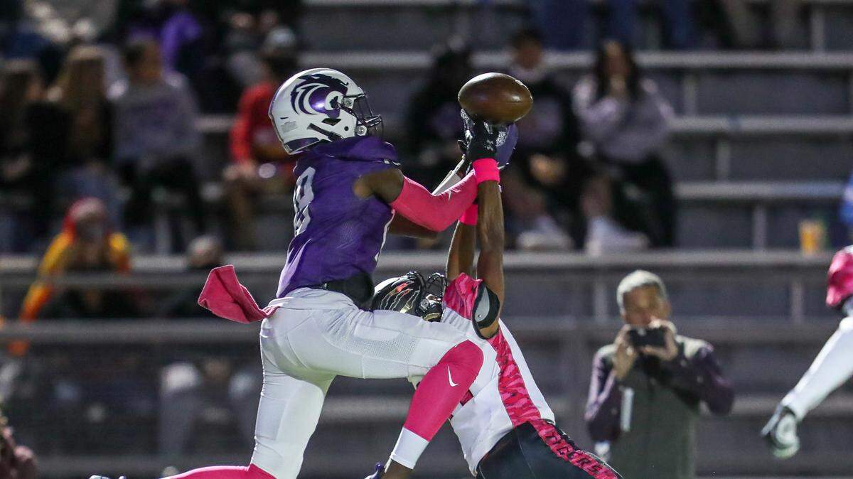 Park Hill South wide receiver Mudia Reuben (in purple) goes high for a catch during the first quarter that is broken up by Lee’s Summit’s Max Kates during the game Friday on October 15, 2021, in Kansas City.
