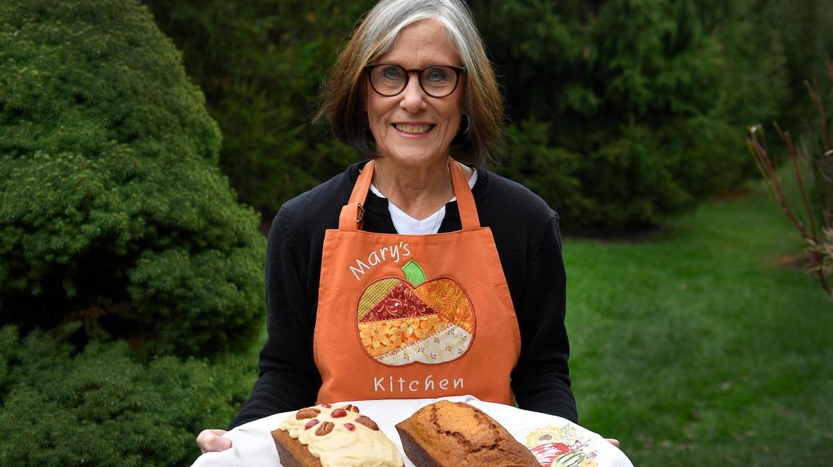 Mary Bodney with her pumpkin bread, one with a caramel glaze.