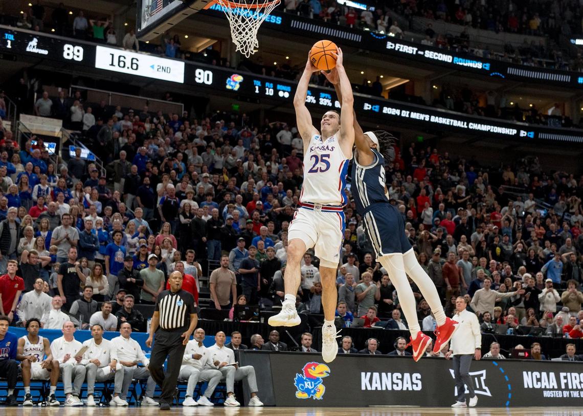 Samford guard A.J. Staton-McCray (5) is called for a foul while blocking Kansas Jayhawks guard Nicolas Timberlake (25) in the second half of a first-round NCAA Tournament game on Thursday, March 21, 2024, in Salt Lake City, Utah.