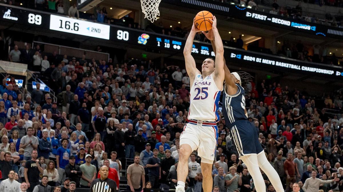 Samford guard A.J. Staton-McCray (5) is called for a foul while blocking Kansas Jayhawks guard Nicolas Timberlake (25) in the second half of a first-round NCAA Tournament game on Thursday, March 21, 2024, in Salt Lake City, Utah.