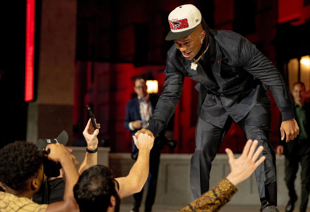 Texas running back Bijan Robinson celebrates with fans after being picked eighth overall by the Atlanta Falcons during the NFL Draft outside of Union Station on Thursday, April 27, 2023, in Kansas City.