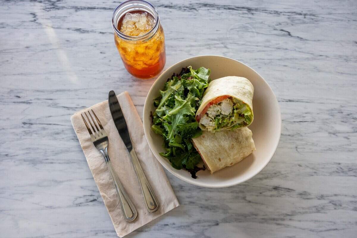 A 1924 wrap and an ice black tea are served at the new Flower Child restaurant in Prairie Village on Friday, Aug. 7, 2026. The 1924 wrap is a grilled chicken teaser wrap.