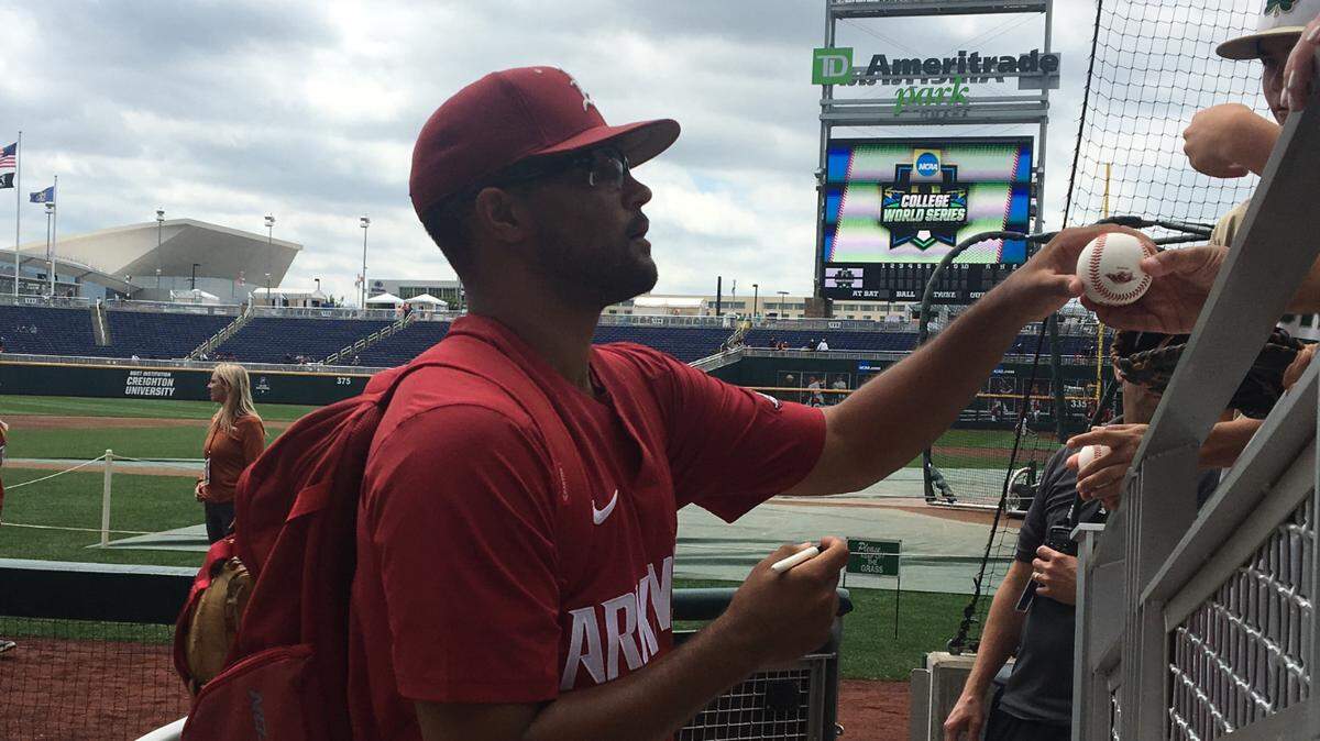 Arkansas pitcher Isaiah Campbell, an Olathe South graduate, signed autographs for fans a day before the College World Series at TD Ameritrade Park in Omaha.