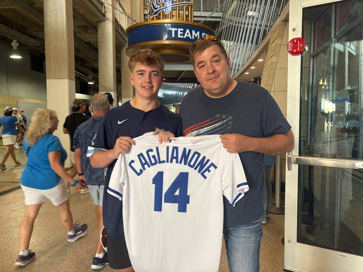 Royals fans Eli (left) and Clint Wolf of Olathe with Eli’s new Jac Caglianone jersey on June 10, 2025.