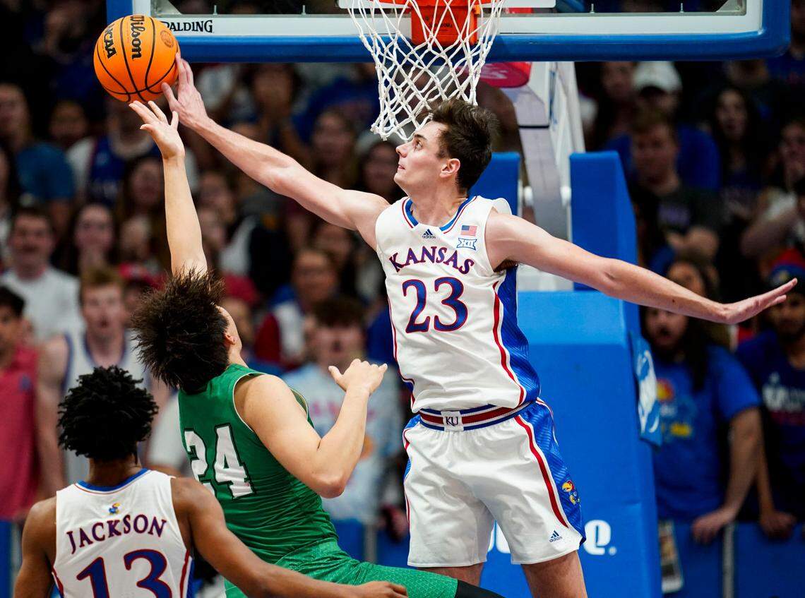Kansas Jayhawks forward Parker Braun (No. 23) blocks the shot of Manhattan Jaspers forward Xinyi Li during Friday night’s game at Allen Fieldhouse.