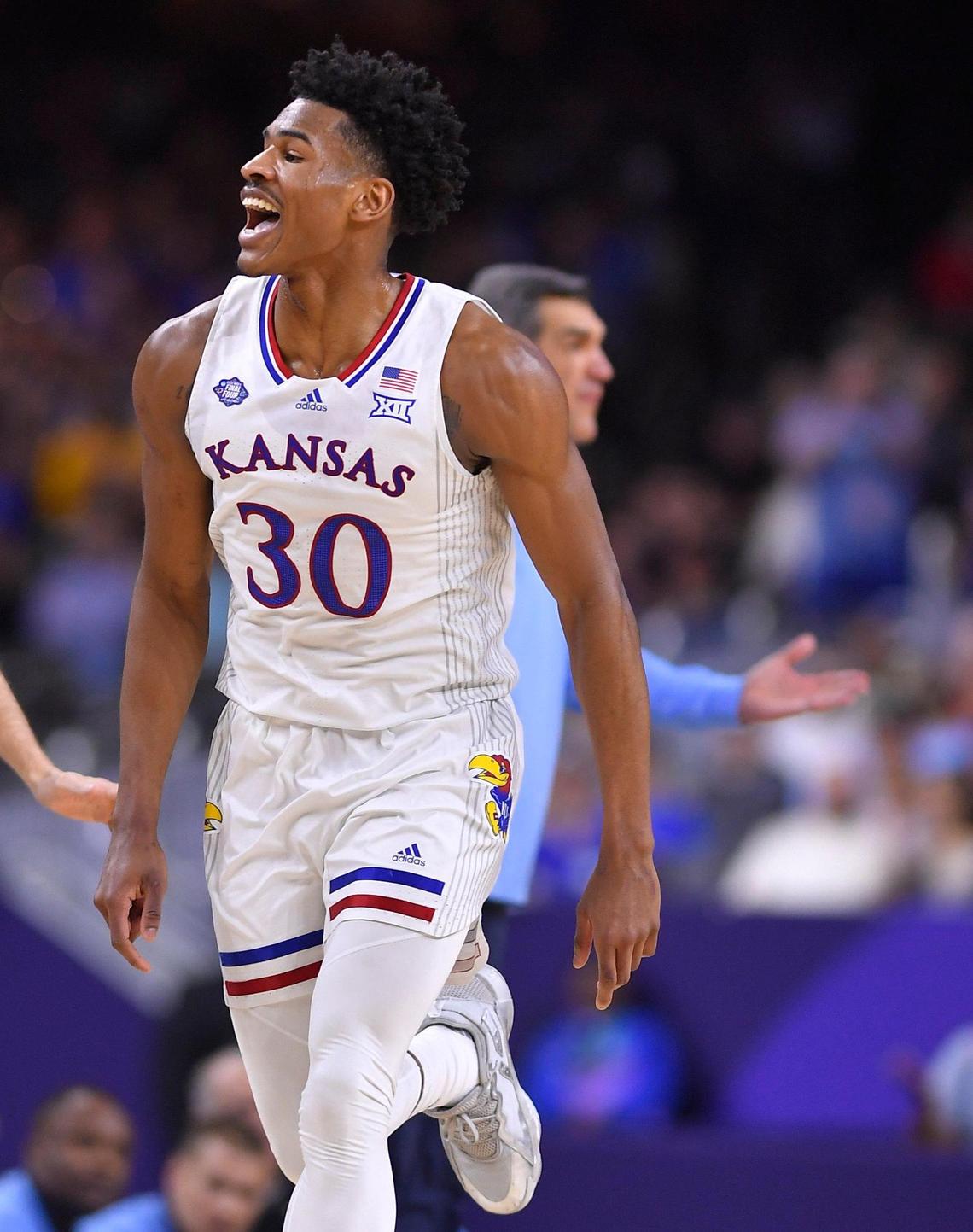 KU’s Ochai Agbaji was all smiles after hitting a three pointer and Villanova coach Jay Wright wasn’t during the first half of Saturday’s NCAA national semifinal at the Final Four at the Superdome in New Orleans.