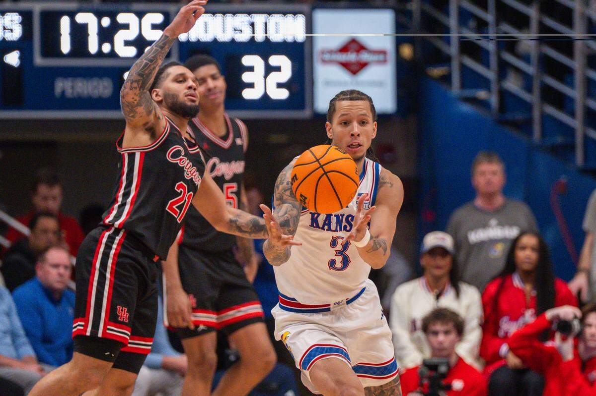 Kansas Jayhawks guard Tre White (3) steals the ball from Houston Cougars guard Emanuel Sharp (21) in the second half on Monday, February 23, 2026, at Allen Fieldhouse.