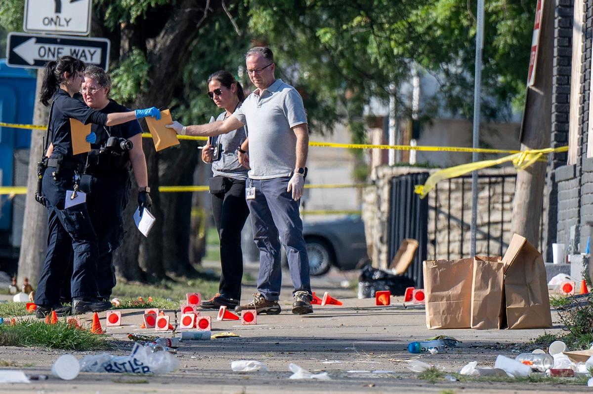 Cones mark evidence at a shooting scene where Kansas City police were investigating an early morning shooting Monday, Aug. 5, 2024, near East 70th Street and Prospect Avenue.