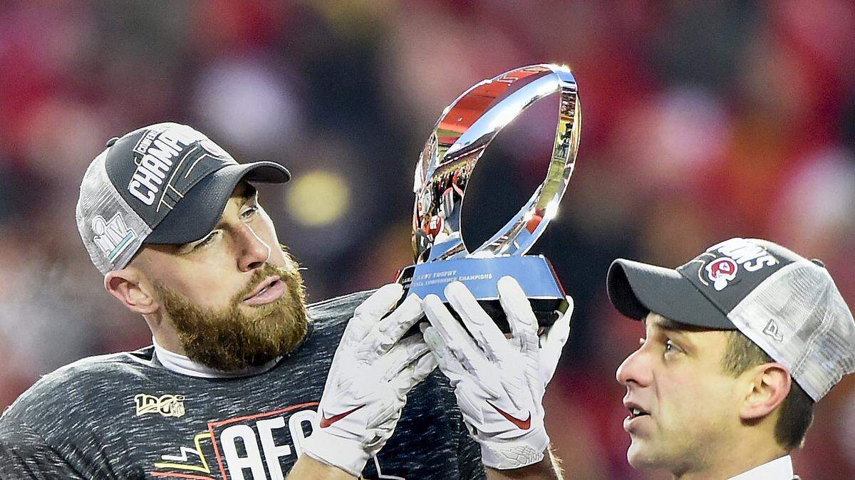 Kansas City Chiefs tight end Travis Kelce held the Lamar Hunt Trophy as Chiefs general manager Brett Veach looked on after the Chiefs captured the 2019 AFC Championship by defeating the Tennessee Titans, 35-24.