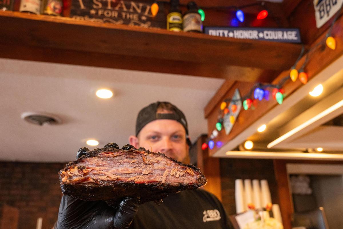 Josh Deal, owner of J’s BBQ, shows off the beginning of a batch of burnt ends at his new restaurant in Olathe.