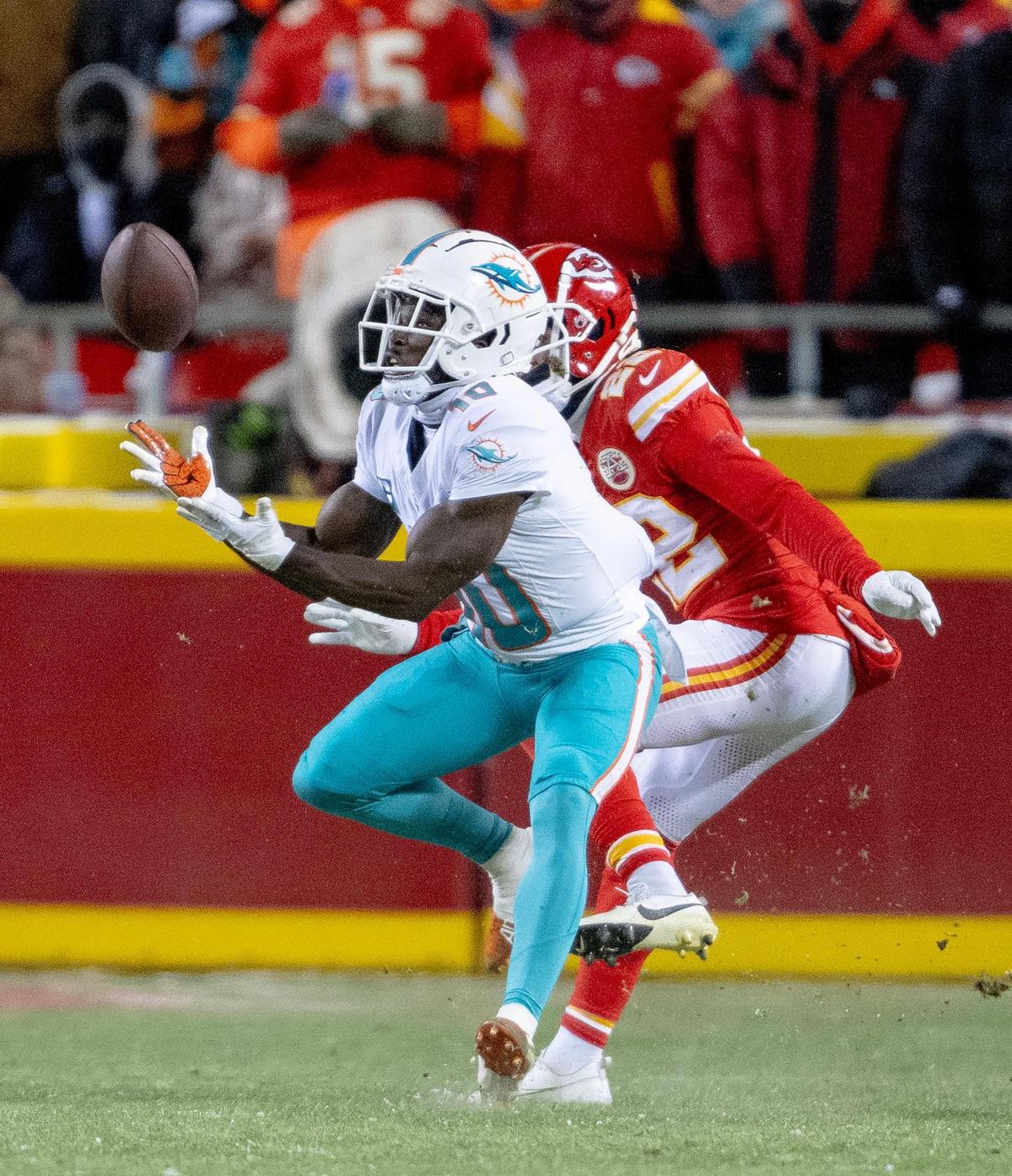Miami Dolphins wide receiver Tyreek Hill (10) catches a touchdown pass as Kansas City Chiefs cornerback Trent McDuffie (22) commits pass interference during an AFC Wild Card game at GEHA Field at Arrowhead Stadium on Saturday, Jan. 13, 2024, in Kansas City.