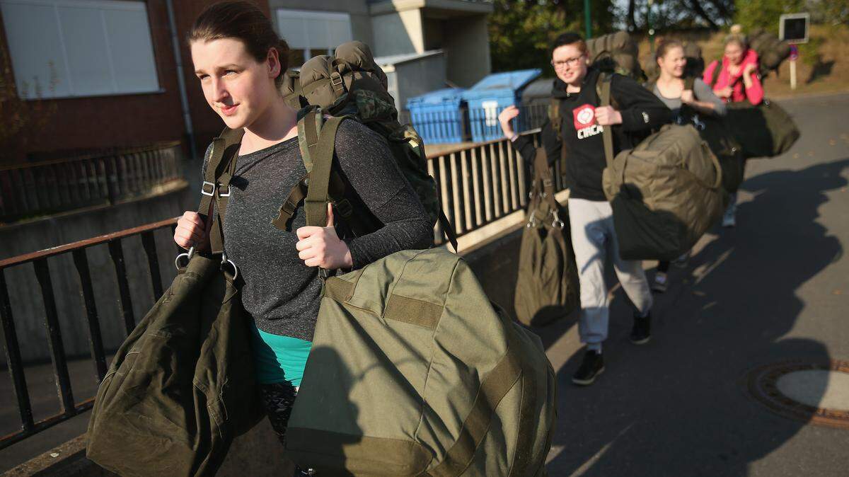 Women carrying backpacks.