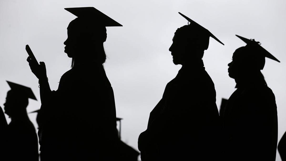 FILE - In this May 17, 2018, file photo, new graduates line up before the start of the Bergen Community College commencement at MetLife Stadium in East Rutherford, N.J.  A deadline is fast approaching for teachers, librarians, nurses and others who work in public service to apply to have their student loan debt forgiven. New figures from the U.S. Department of Education show 145,000 borrowers have had the remainder of their debt canceled through the Public Service Loan Forgiveness program. (AP Photo/Seth Wenig, File)