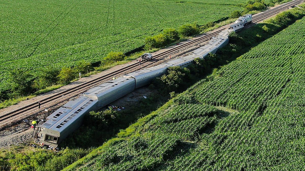 Several passenger cars and the engines of an Amtrak train rest on their sides after the train hit a truck at a crossing Monday near Mendon, Missouri. At least three people died in the accident, two passengers and the truck driver, and several others were injured.