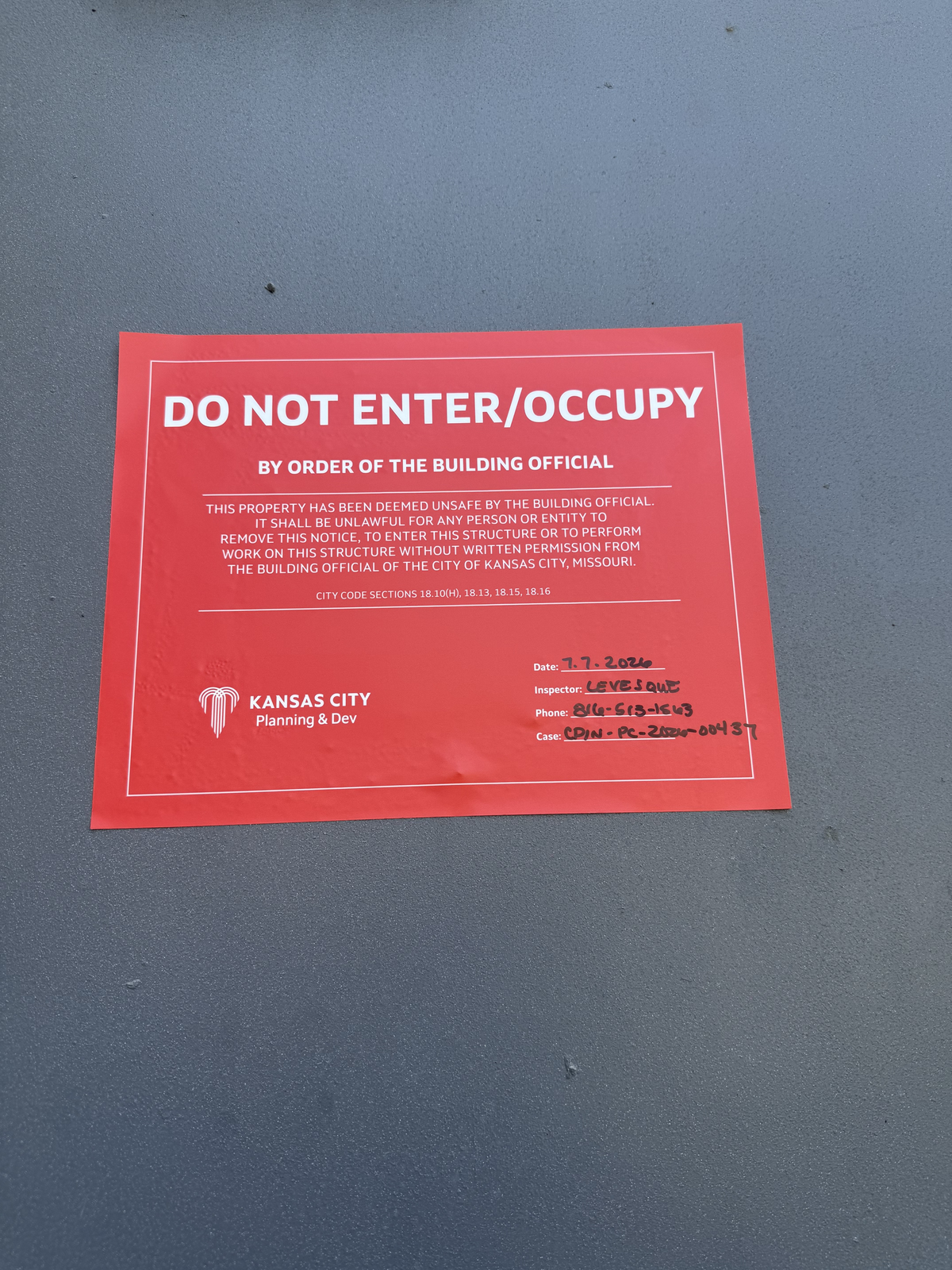 Residents in three northeast Kansas City apartment buildings allege the city briefly told tenants they needed to vacate their residences in 24 hours on July 7, 2026. This sign was posted at one of the properties.