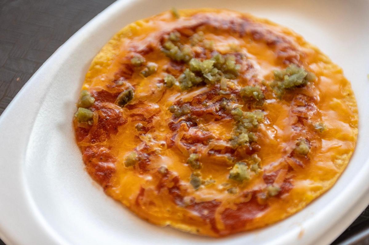 The nacho, one of the most popular menu items at Taco Via in Overland Park, is made on a tostada with melted cheese, taco sauce and diced jalapeño sprinkled on top.
