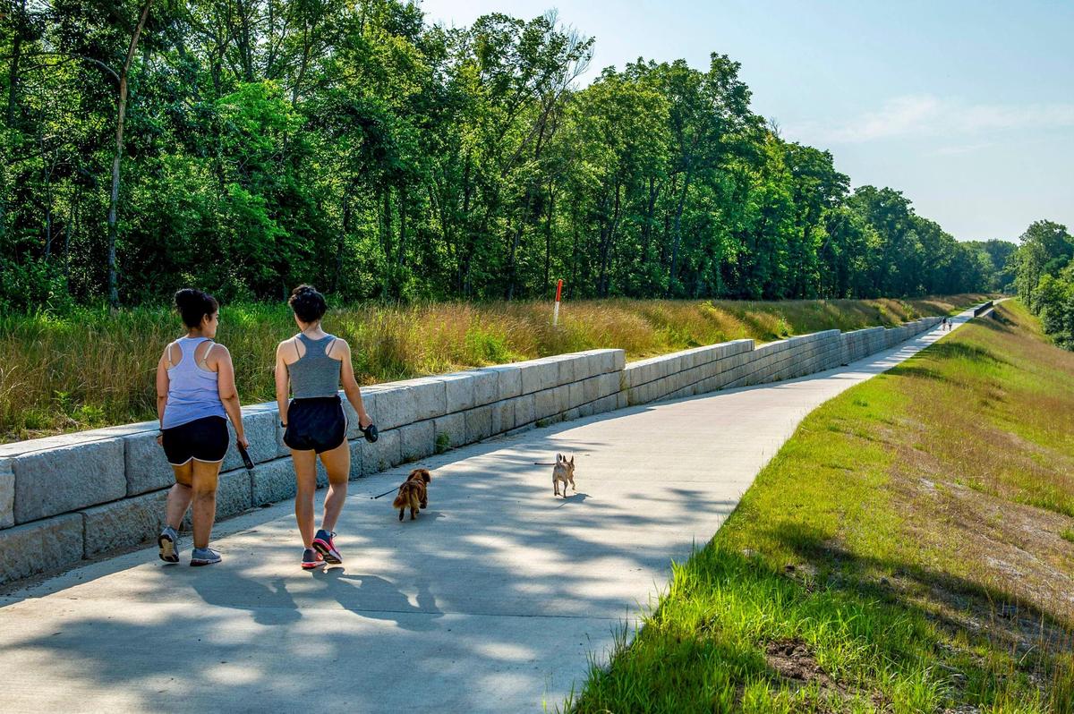 Pedestrians walk on the Rock Island Trail head, Monday, July 5, 2021 in Kansas City. A ceremony for the completion of the Rock Island Trail will be held at 10 a.m. Saturday, July 10, 2021 at the northernmost trailhead in parking lot L of the Truman Sports Complex.