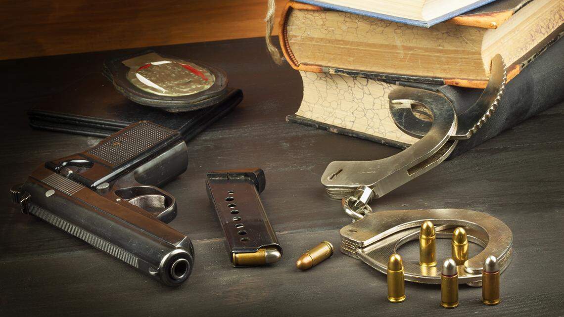 Police gun and badge. Weapons to defend law and order. The right to own a gun. Defense Law. Crime and Punishment. firearm handgun pistol legal