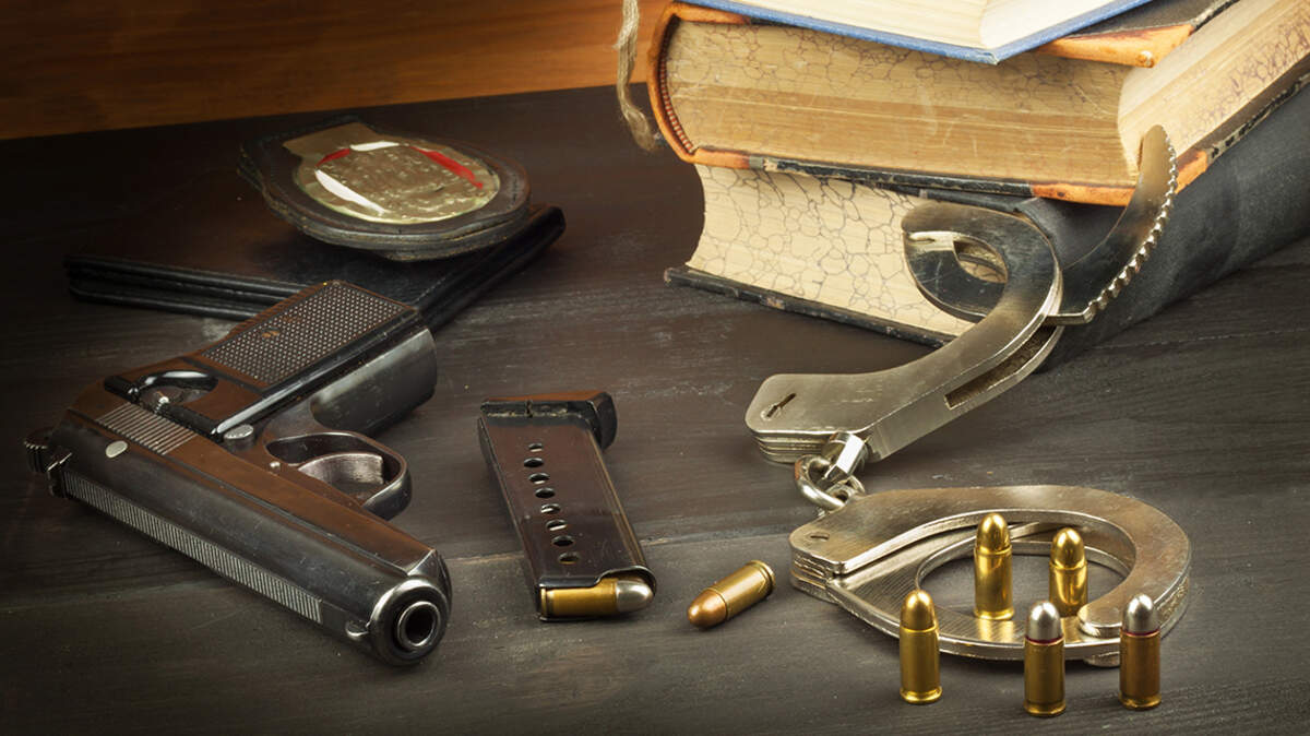 Police gun and badge. Weapons to defend law and order. The right to own a gun. Defense Law. Crime and Punishment. firearm handgun pistol legal