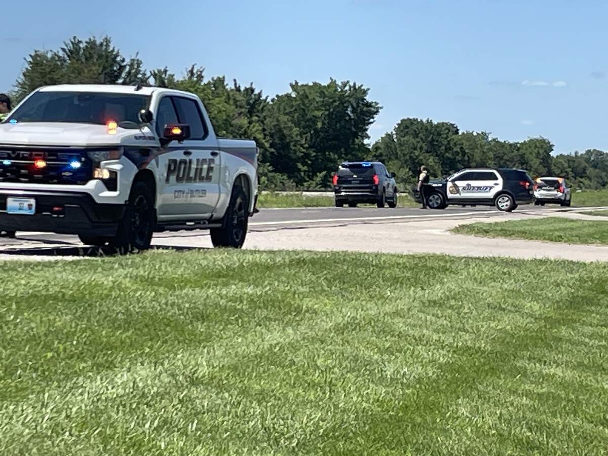 Butler Police and other law enforcement vehicles block a highway in near the Butler Memorial Airport, where a small airplane crashed killing all onboard. June 14, 2026.