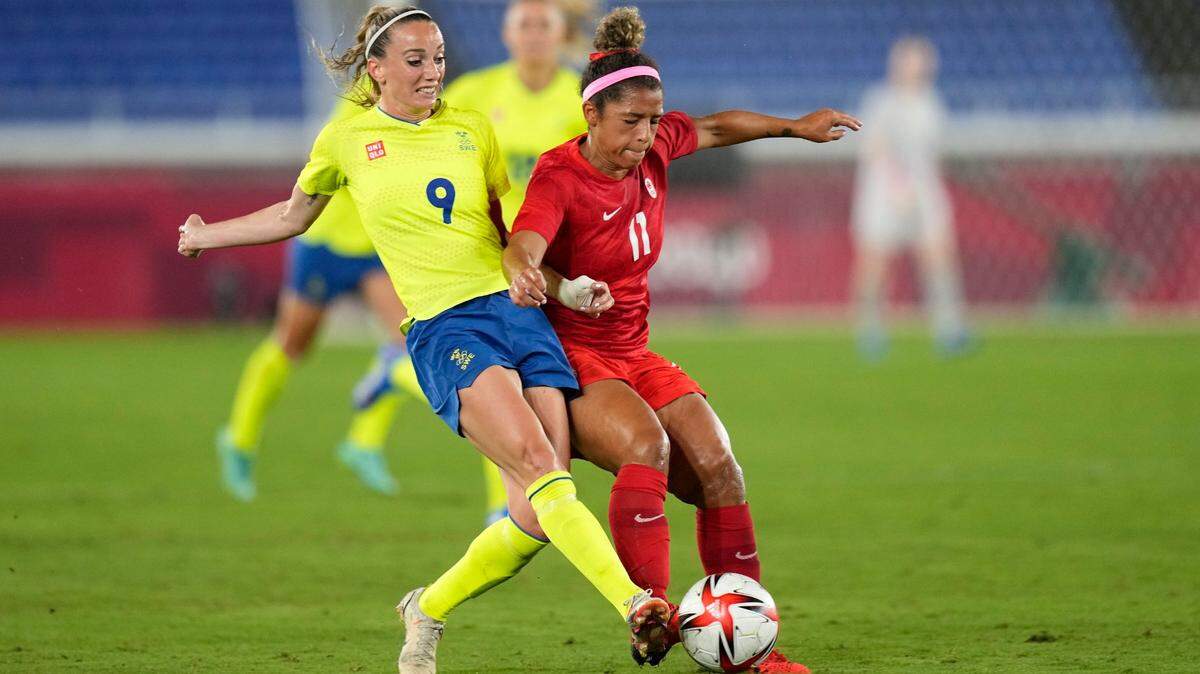 Playing for her native Canada, KC NWSL midfielder Desiree Scott, right, battles Sweden’s Kosovare Asllani for the ball during the women’s gold medal soccer final at the Toyko Olympics.