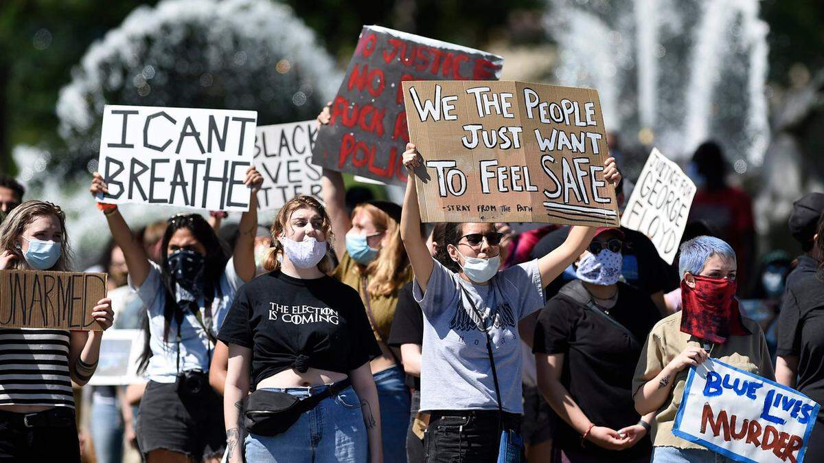 People protesting police brutality and the death of George Floyd gathered Friday, May 29, 2020, at the J.C. Nichols fountain on the Country Club Plaza in Kansas City. Protests have been erupting all over the country after George Floyd died earlier this week in police custody in Minneapolis.
