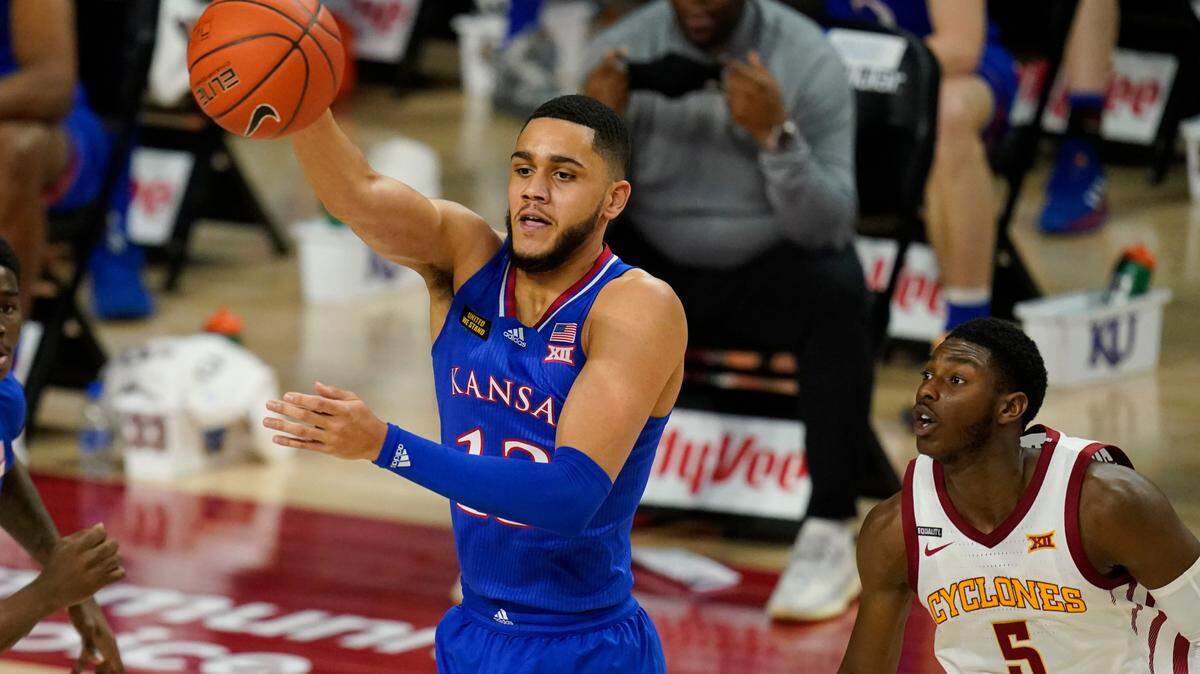Kansas guard Tristan Enaruna passes in front of Iowa State guard Jalen Coleman-Lands, right, during the first half of an NCAA college basketball game, Saturday, Feb. 13, 2021, in Ames, Iowa. (AP Photo/Charlie Neibergall)