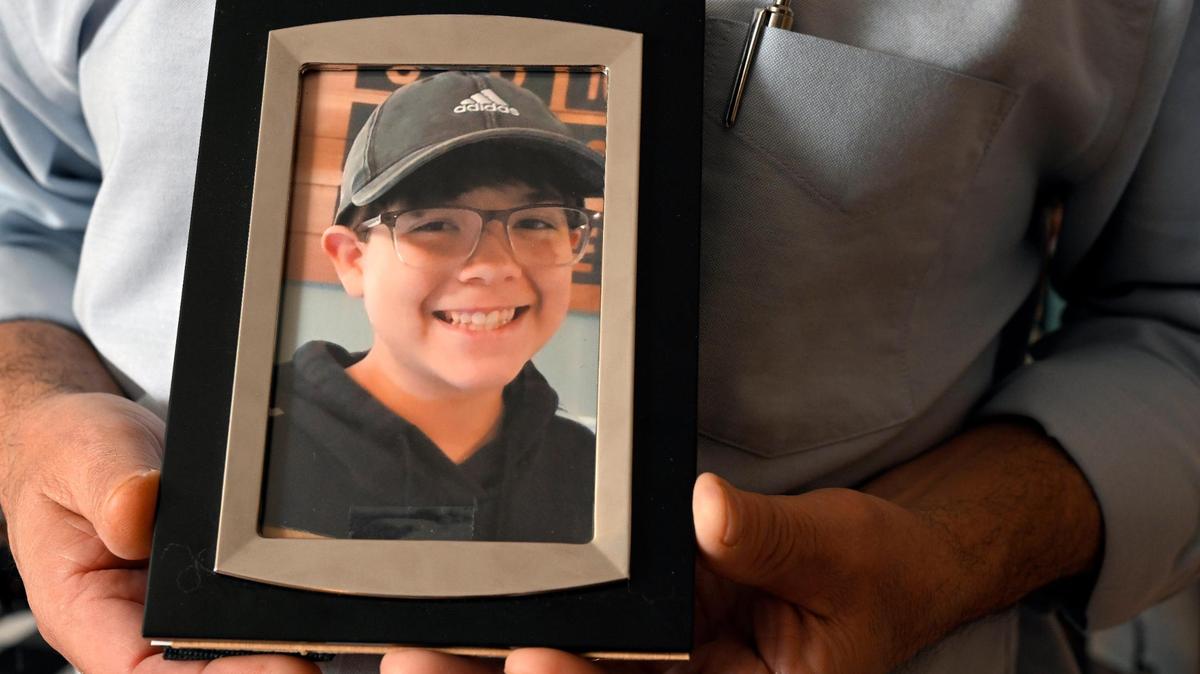 Andy Burris of Lansing, Kansas, holds a photo of his beloved, 15-year-old son, Nicholas “Cruz” Burris, who died of fentanyl poisoning at home on Jan. 18, 2023.