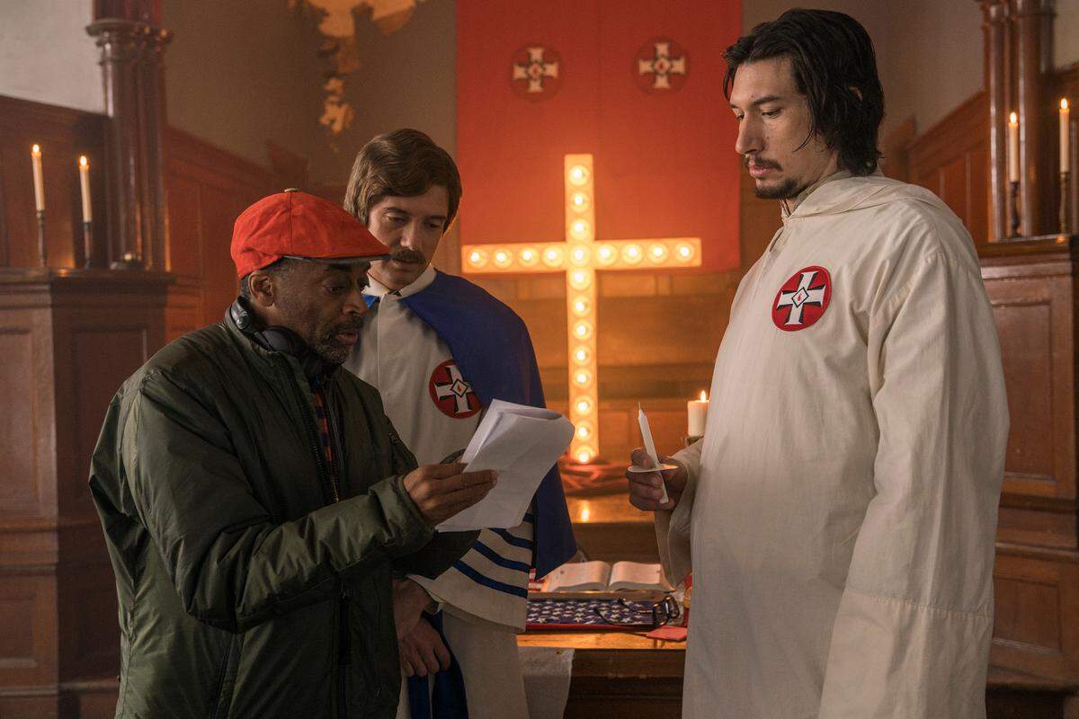 On the set of “BlacKkKlansman,” director Spike Lee talks with Topher Grace, who plays Ku Klux Klan leader David Duke, and Adam Driver, who plays a stand-in for black detective Ron Stallworth.