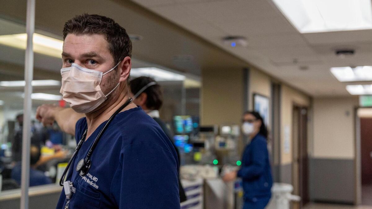 Dr. Marc Larsen, an emergency physician at Saint Luke’s seen here at work during the COVID pandemic, said Kansas City emergency rooms are full of people with influenza. Though masks are no longer required there like they were during the pandemic, he is wearing one now while treating people with respiratory illness symptoms to keep from getting sick.