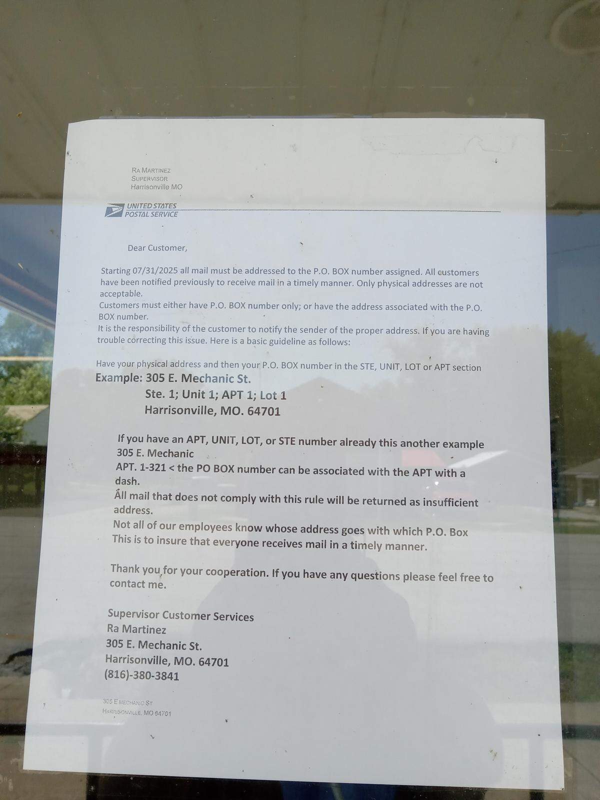 The notice posted on the door of the East Lynne, Missouri, post office, stating that all packages must have a PO box address on them or they will be sent back. Residents have criticized the change, which went into effect on Thursday.