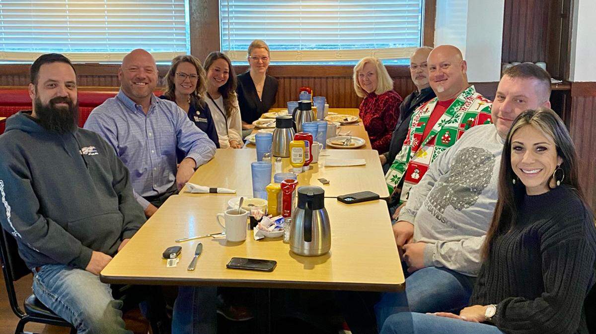 A group of customers at Red Apple Diner on Barry Road gave their server a Santa-sized “Shock and Claus” tip Wednesday. Local businessman Todd Nitsche, second from left, has organized several other such outings.