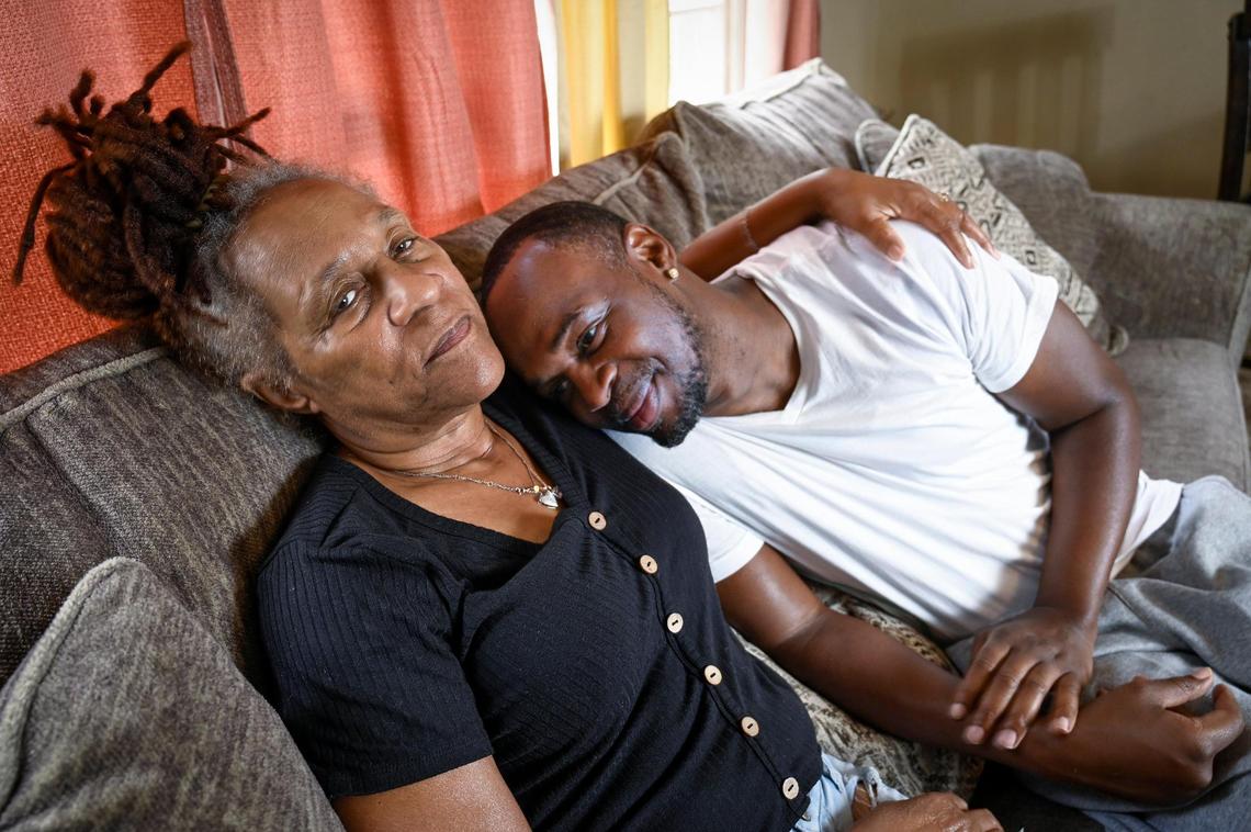 Ophelia Williams, 60, shares a hug with her youngest son, Ortez Johnson, 36, at her home in Kansas City. At the age of 13, Johnson was arrested with his brothers in 1999 but wasn’t charged.