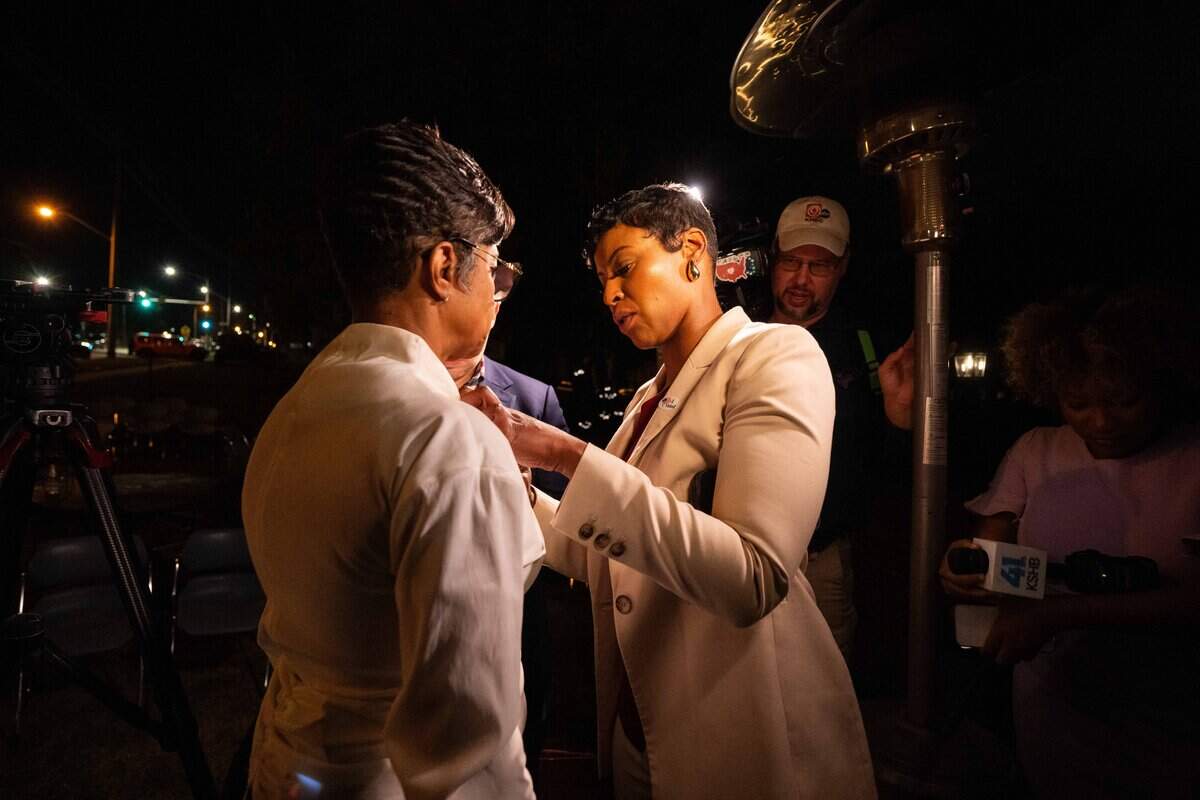Jackson County Prosecutor Melesa Johnson adjusts the microphones for Christal Watson as she waits on election results at John's Java and Jazz in Kansas City on Tuesday, Nov. 4, 2025.