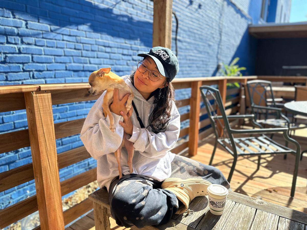 Jackie Nguyen sat in the back patio at Café Cà Phê clutching her Chihuahua, Lixi, collecting her thoughts about the election and about her business that had been violated for a third time in four years.