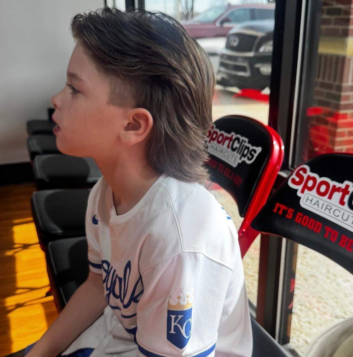 A young Royals fan named Benny shows off his hairstyle based on shortstop Bobby Witt Jr. His brothers Brooks and Bennett also have the updated version of a mullet.